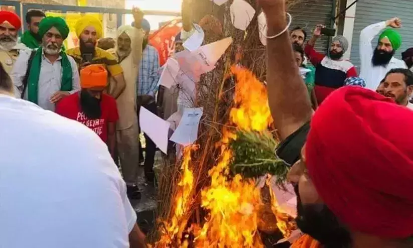 Farmers burn the three farm bills to celebrate Holika Dahan