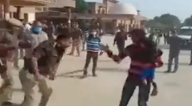 UP police order probe into video of man with child being thrashed by police officer