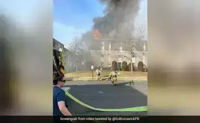 Tossing his infant out of a window, a father jumps to escape a building fire; video goes viral