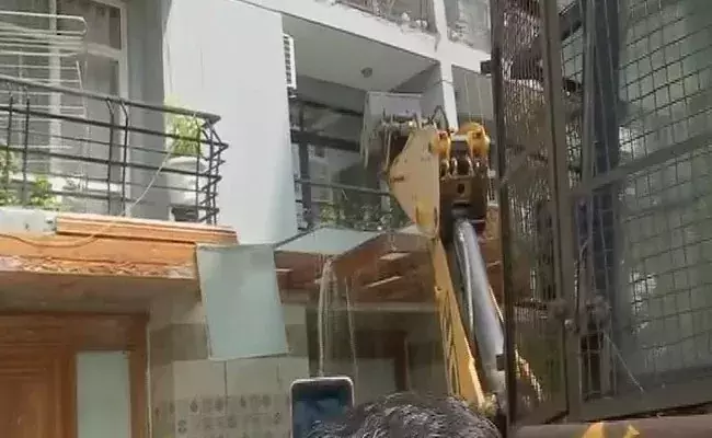 Bulldozers pull down BJP members illegal structures in Noida, after he traded abuses with a woman