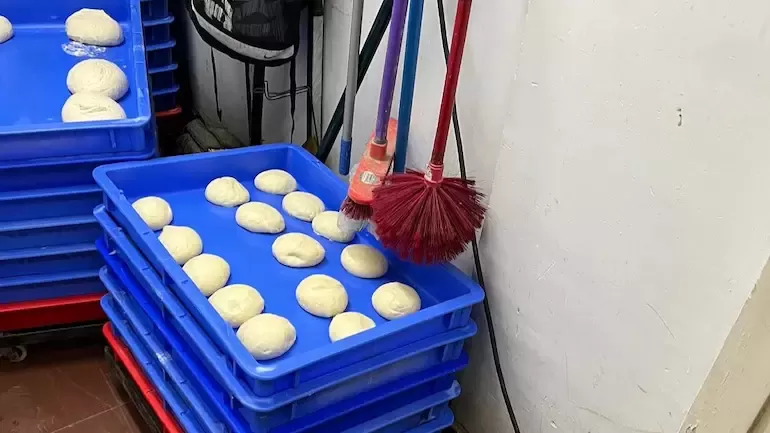 Dominos under fire after pic of mops hanging above trays of pizza dough went viral