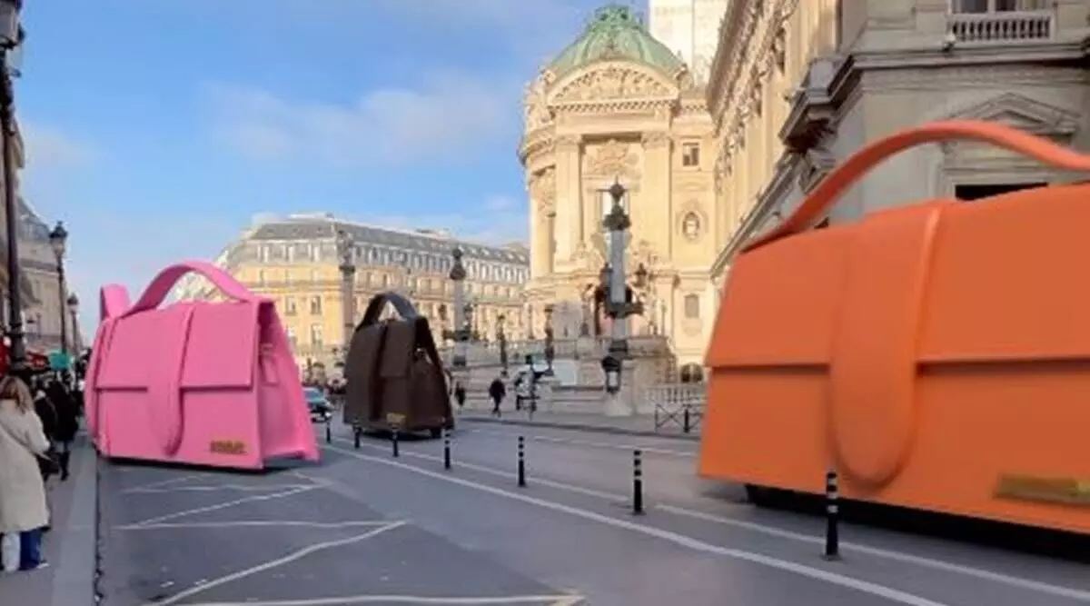 These giant Jacquemus handbags zipping through the streets of Paris have passengers inside